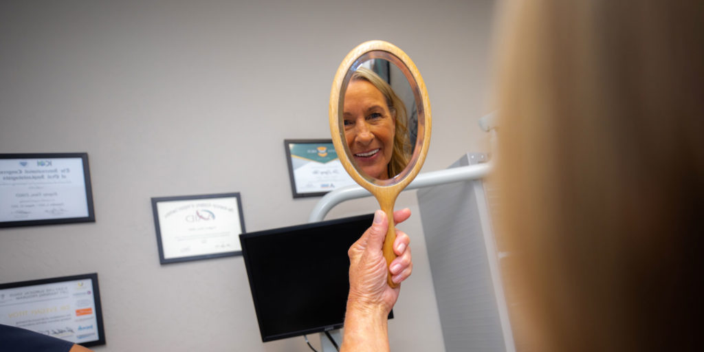 donna with mirror after procedure
