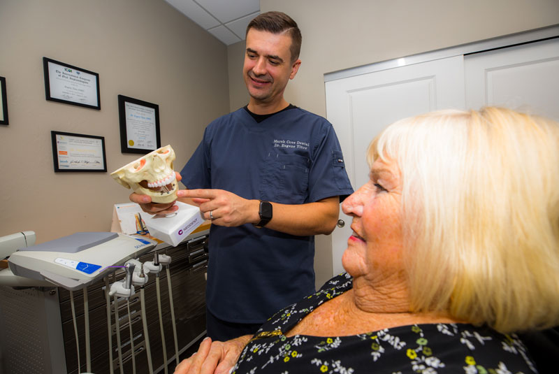 dr titov with jaw bone model with implants