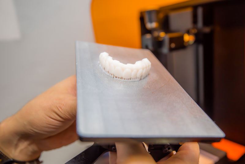dr titov with prothesis full arch and machine
