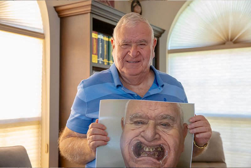 patient holding up their before procedure image inside of the dental practice