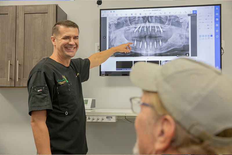 doctor showing dental procedure information to patient